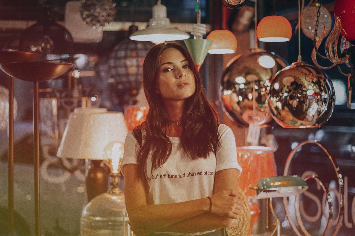 human woman standing in front of assorted lamps people
