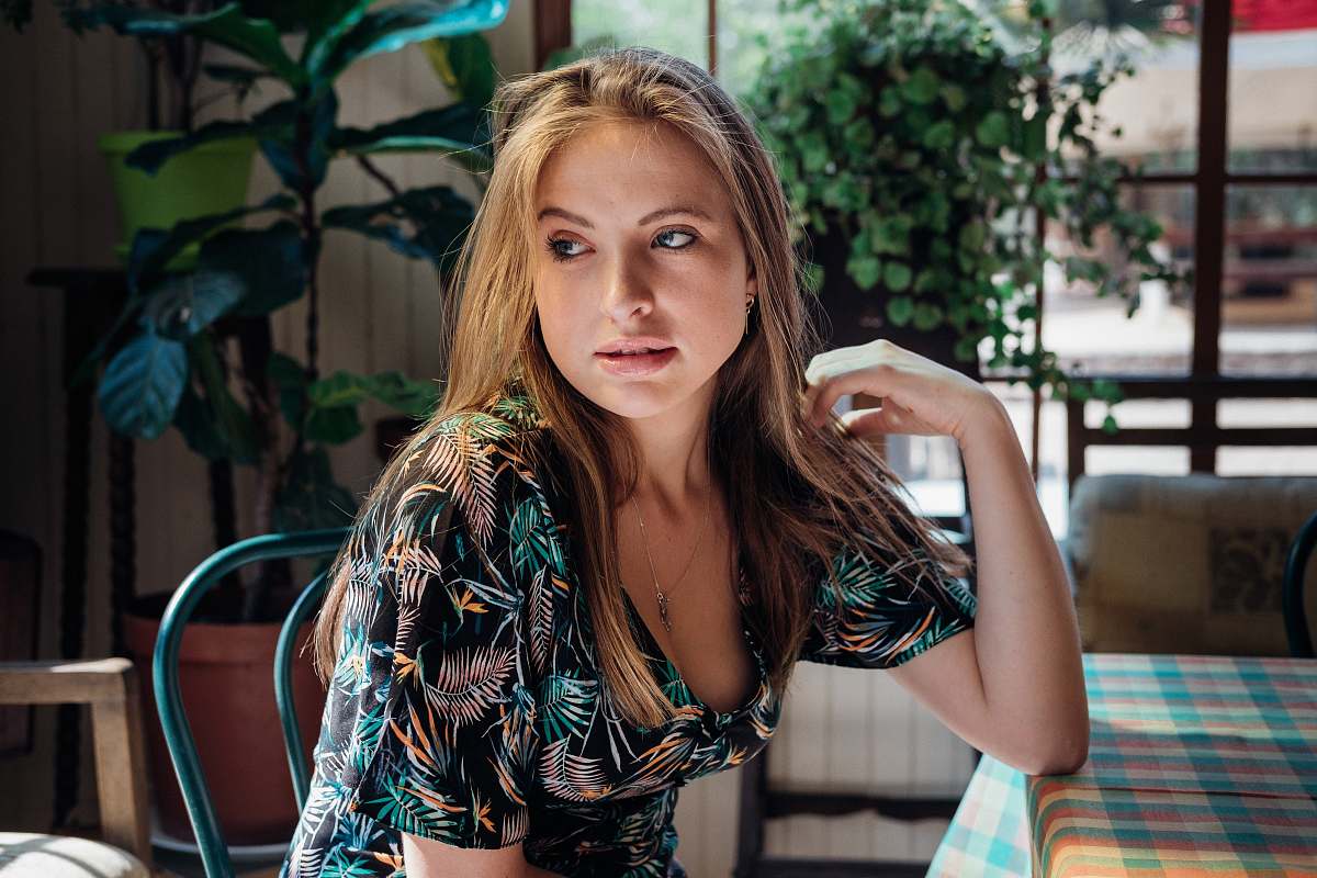 human woman wearing black and blue floral scoop-neck short-sleeved dress people