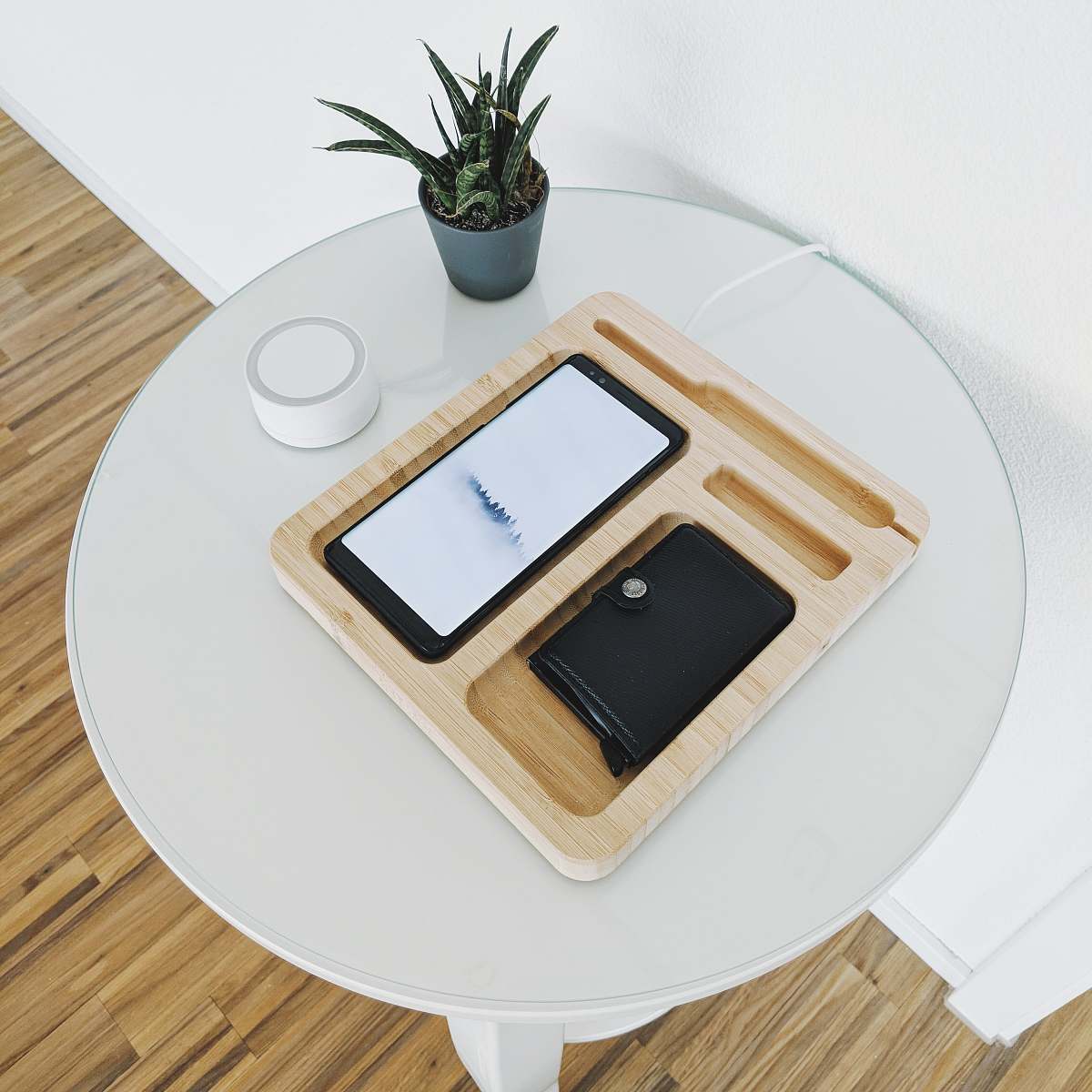 table black smartphone with wallet on wooden tray on table coffee table