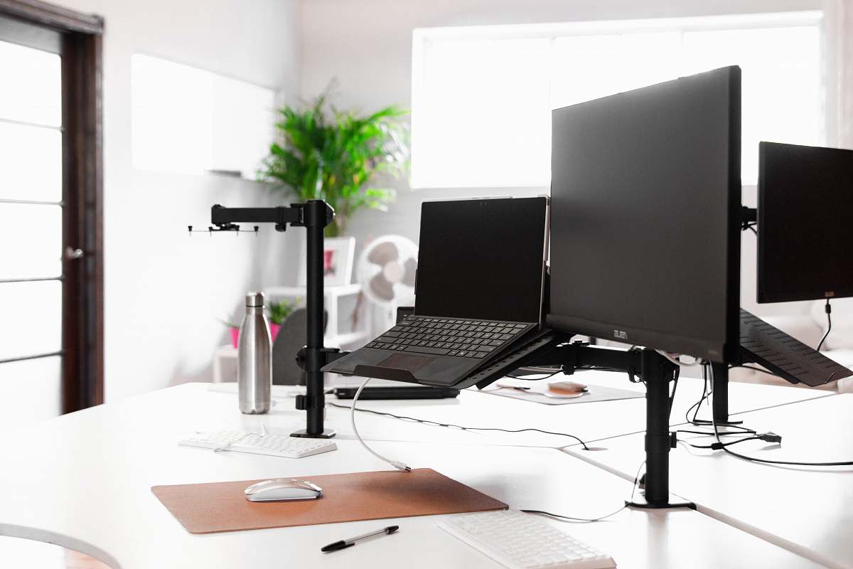 computer laptop, monitor, and vacuum flask on white table flora