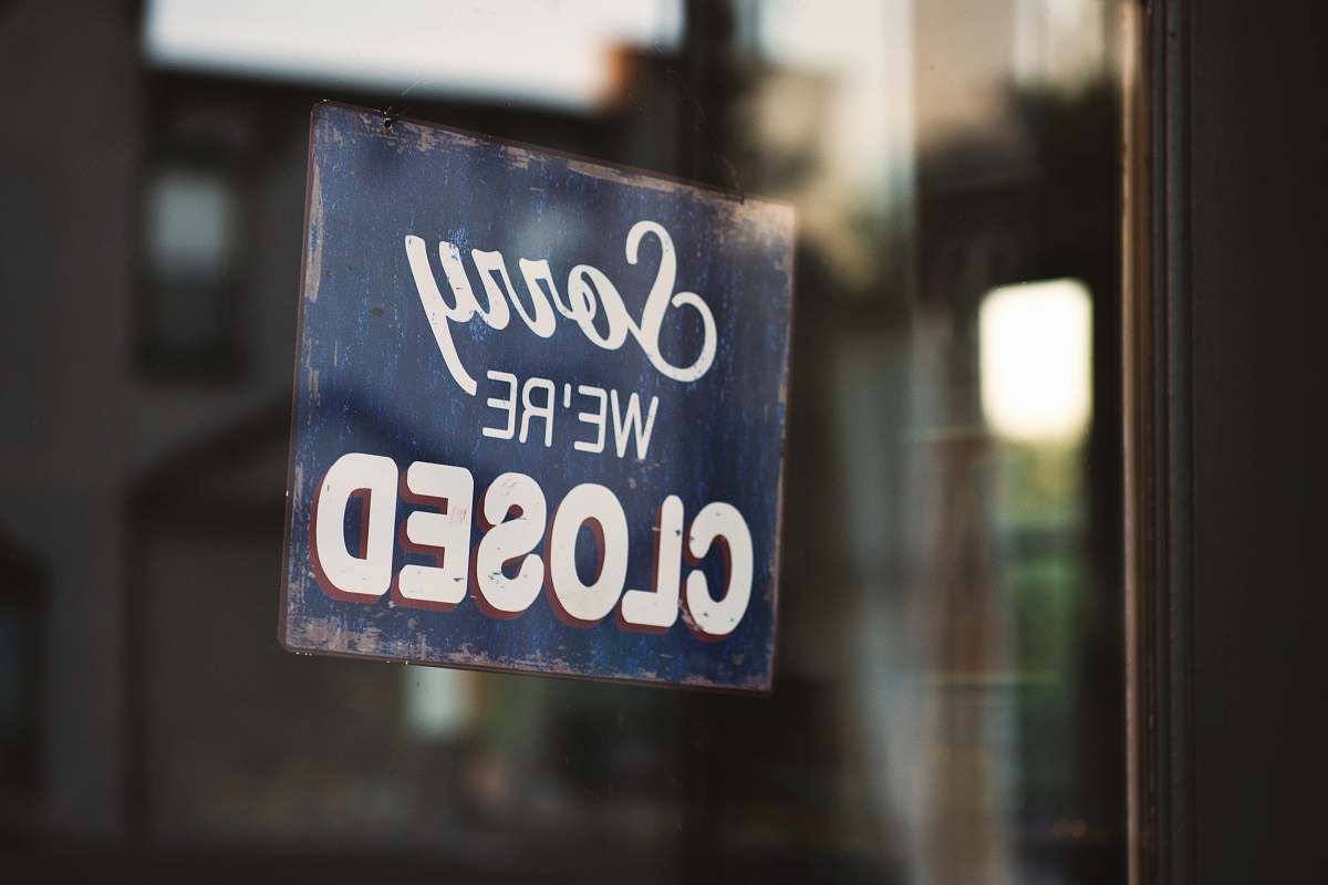 sign Sorry we're closed signage hanged on glass door business