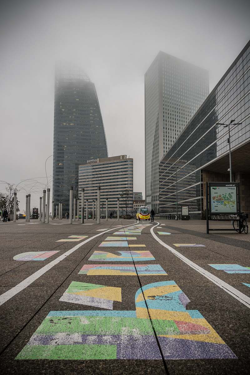 asphalt selective color photography of yellow car near building during daytime tarmac