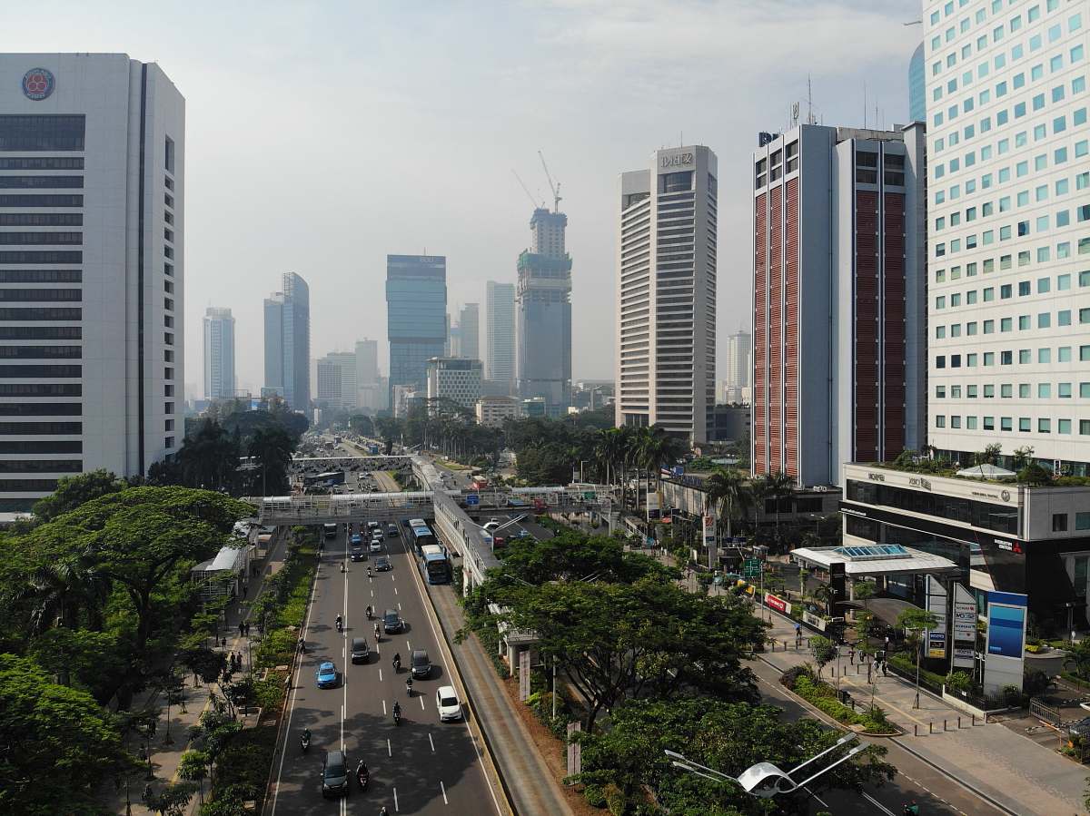 building vehicles on roadway between high rise buildings urban