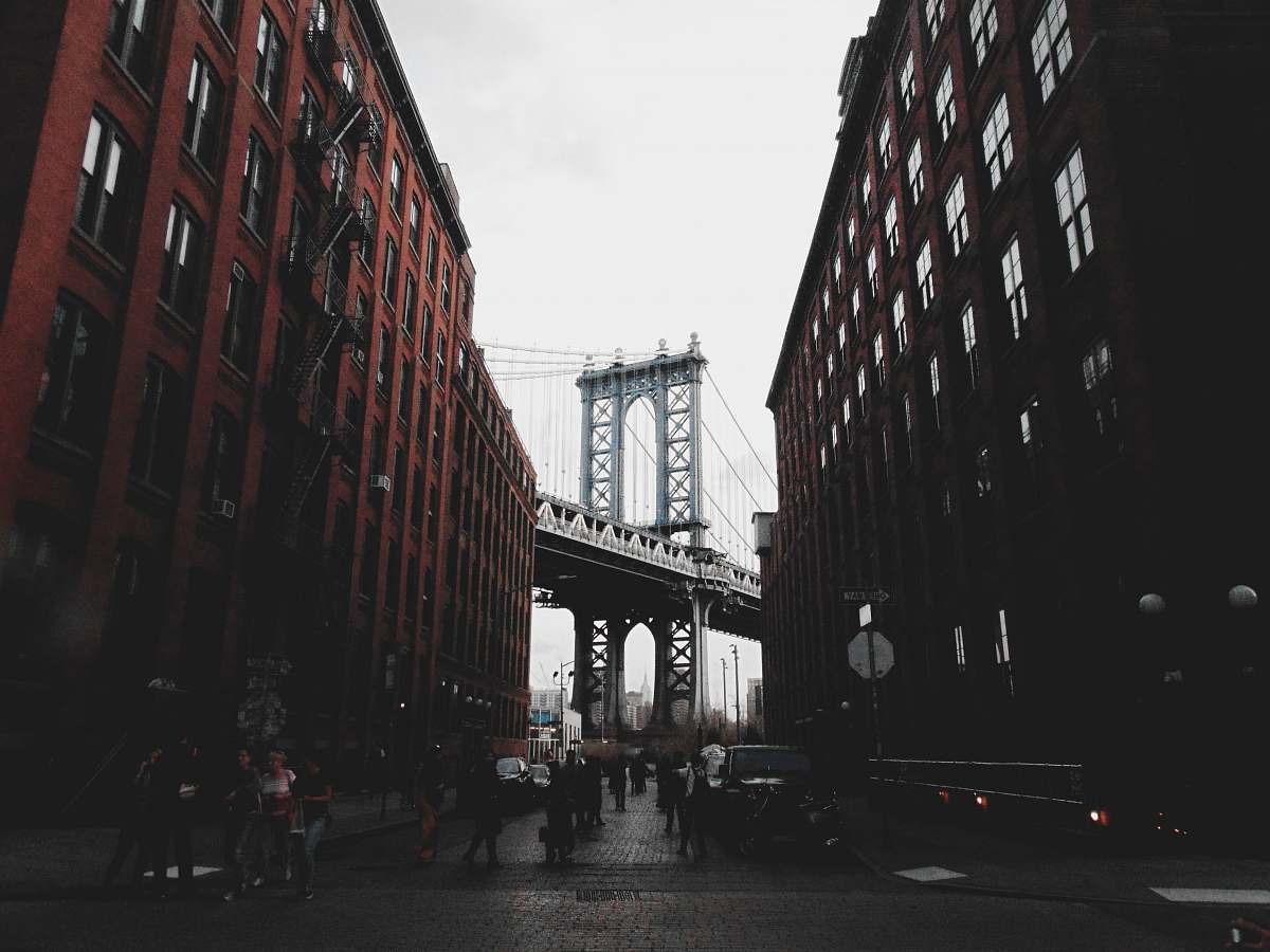 building gray bridge near buildings urban