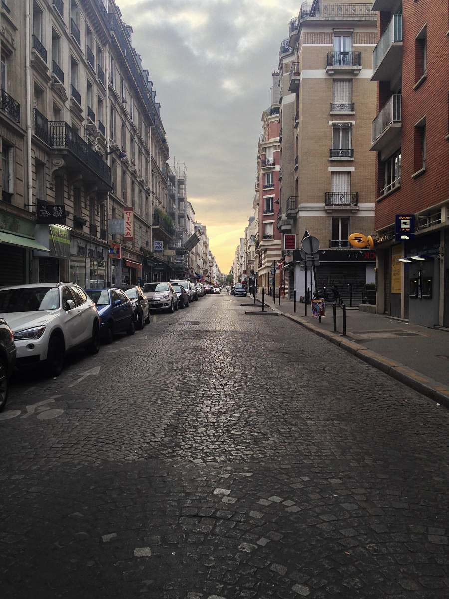 city road street between two buildings road