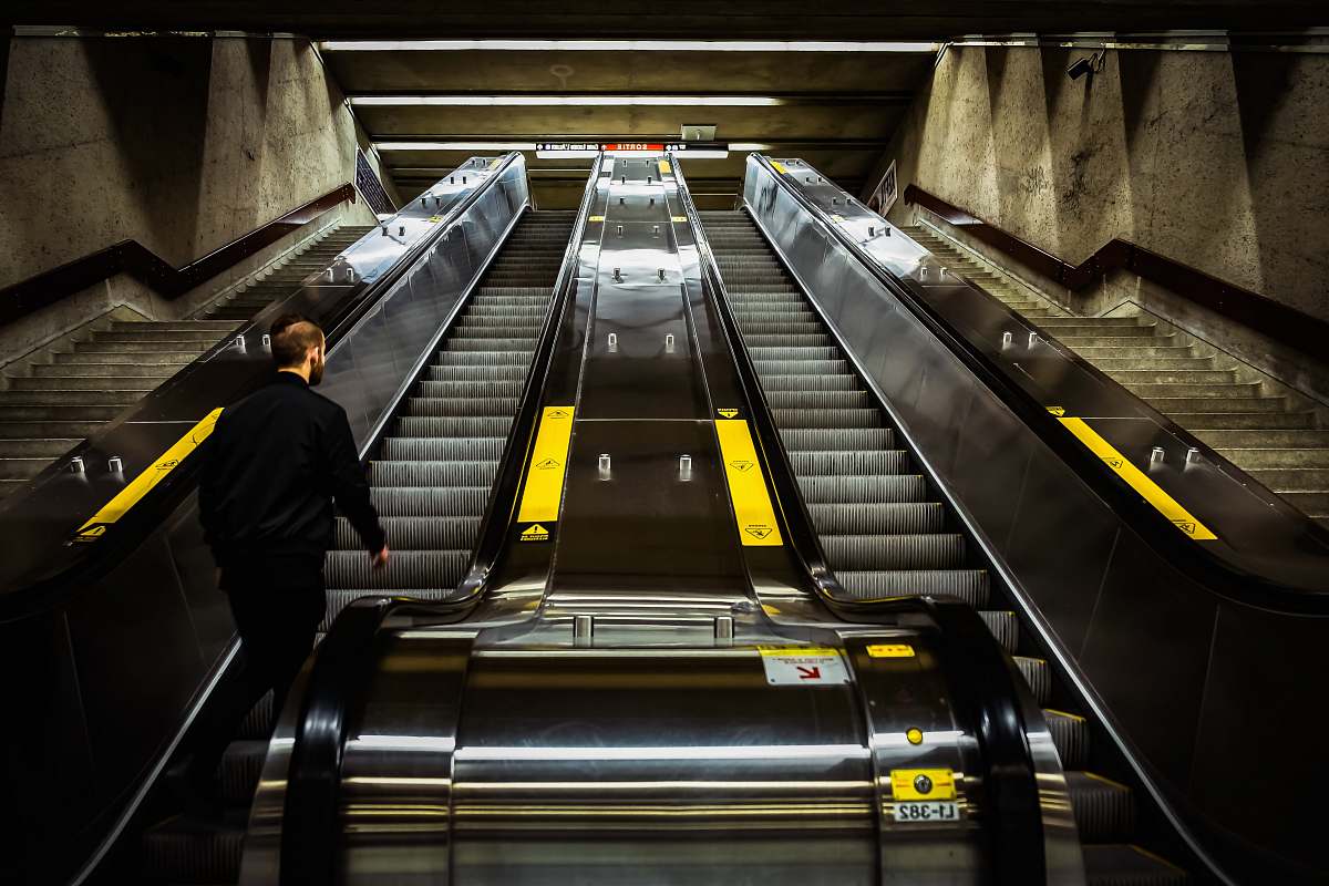 terminal man riding on escalator train
