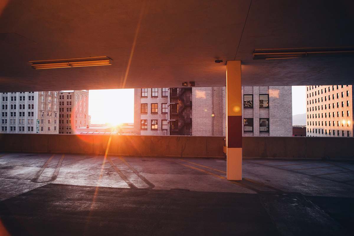 parking two white wall paint buildings during golden hour parking garage