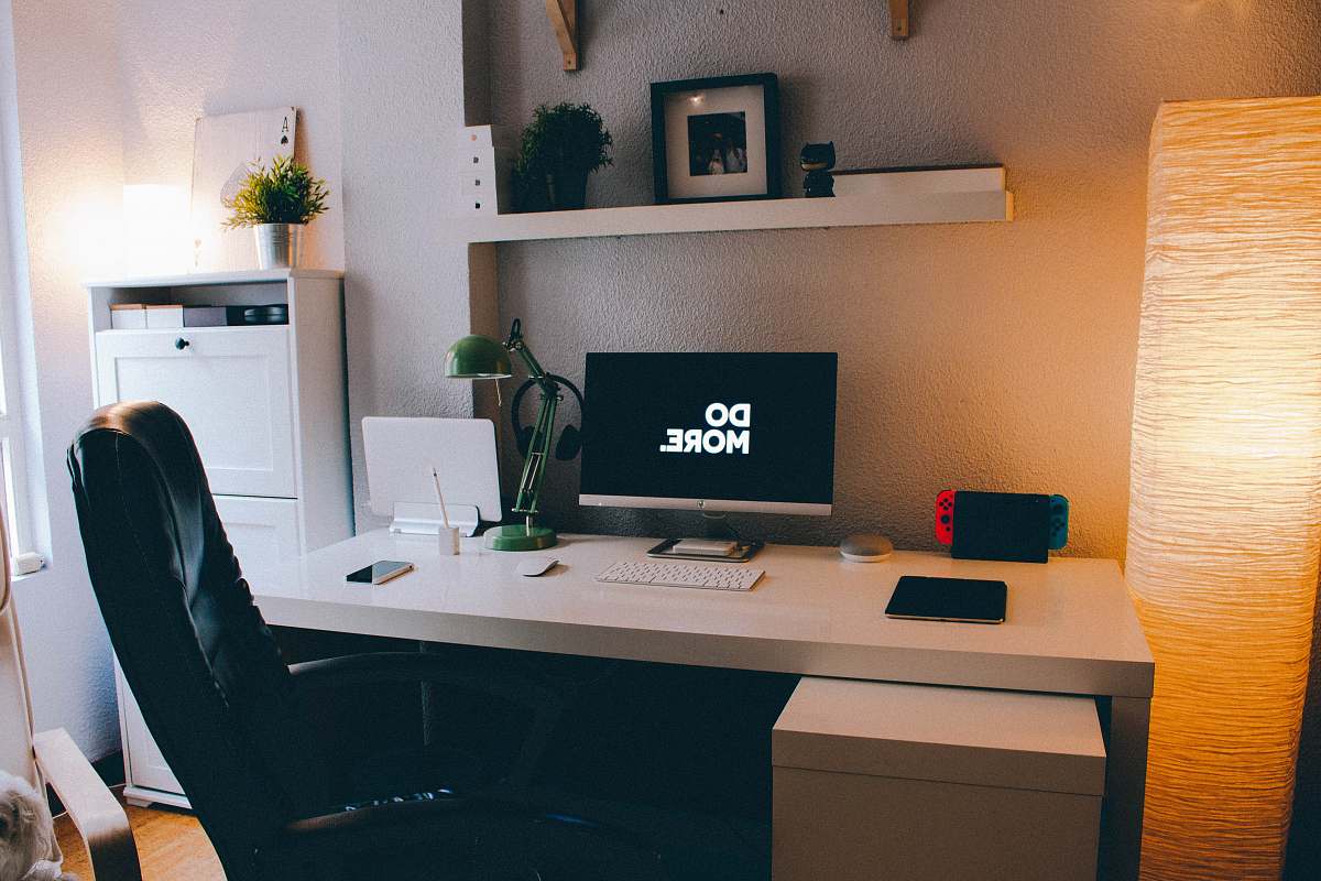 furniture turned-on flat screen computer monitor desk