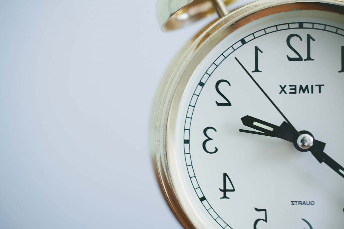gold round Timex analog clock at 2:33 clock