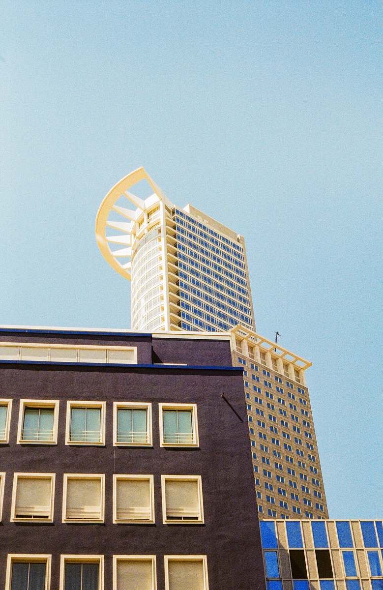 urban brown building under blue sky during daytime high rise
