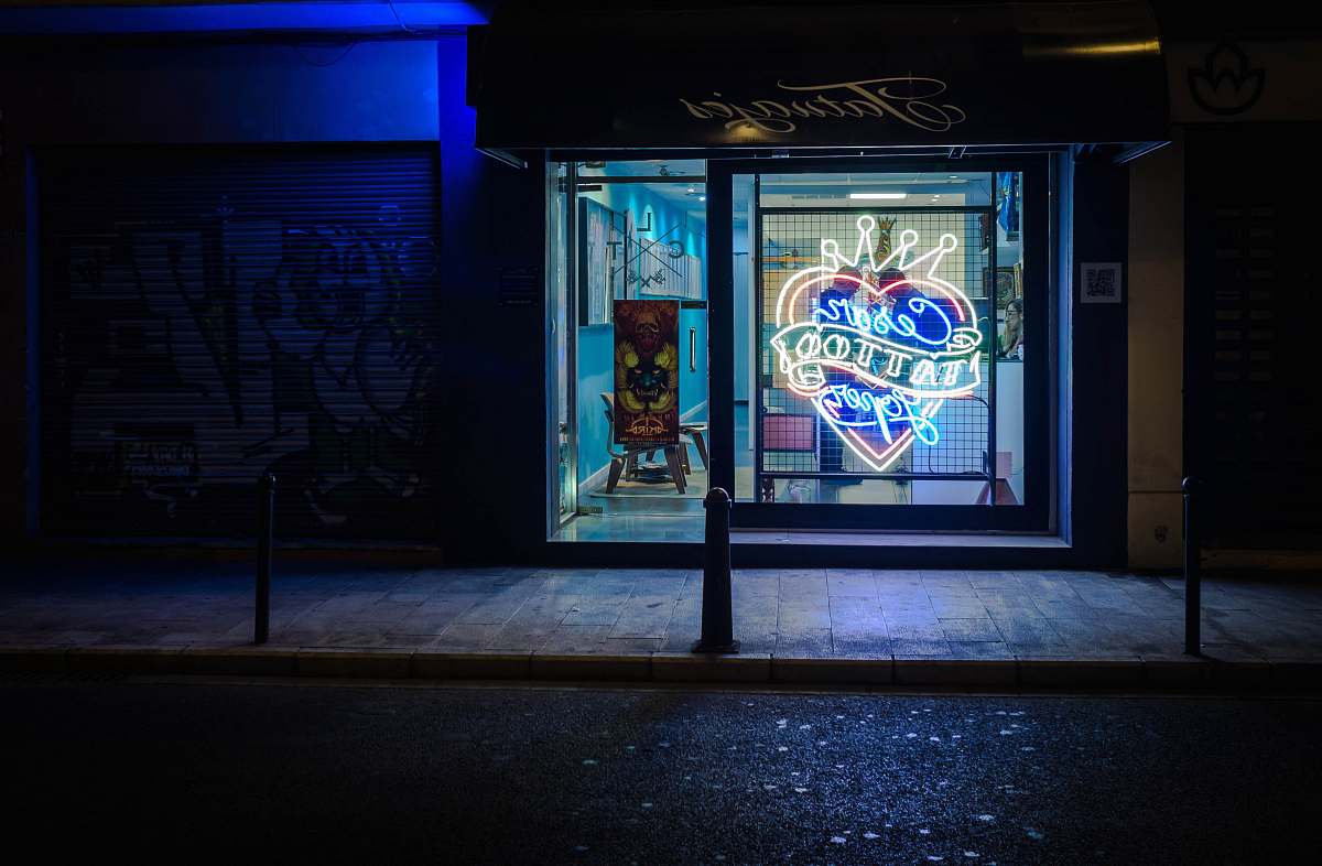 spain landscape photography of neon tattoo sign during nighttime night