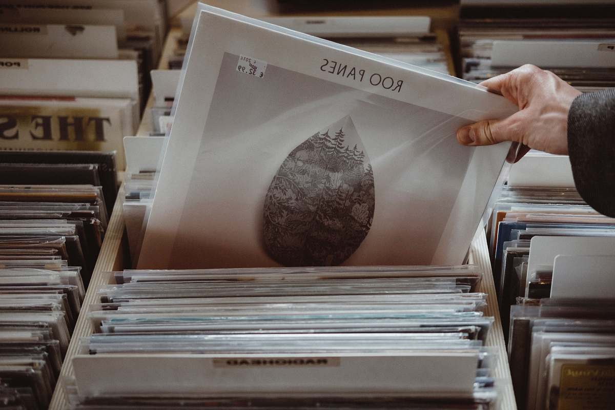 music person holding Roo Panes painting record