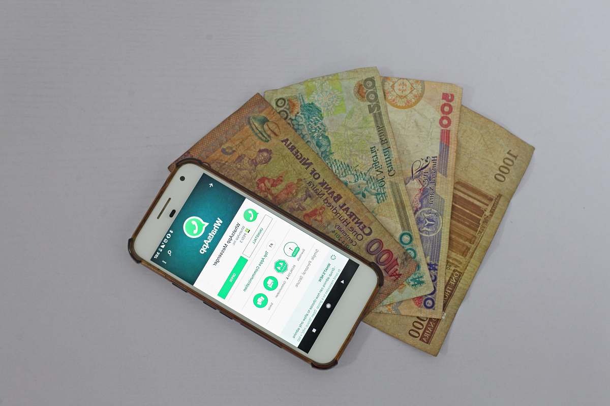 phone white Android smartphone beside banknotes fintech