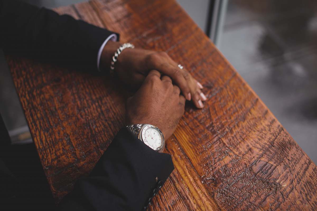 suit person wearing black suit jacket and silver-colored watch hands