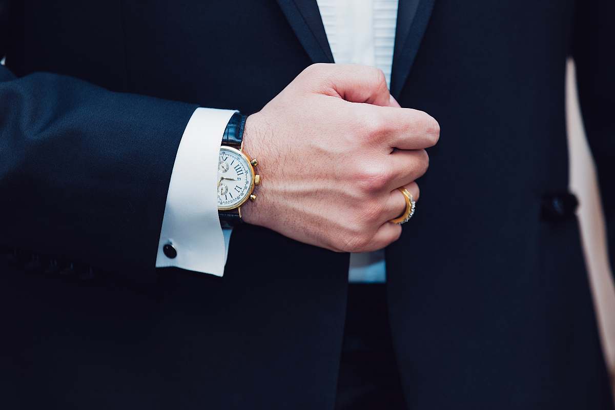hand person wearing black suit jacket man