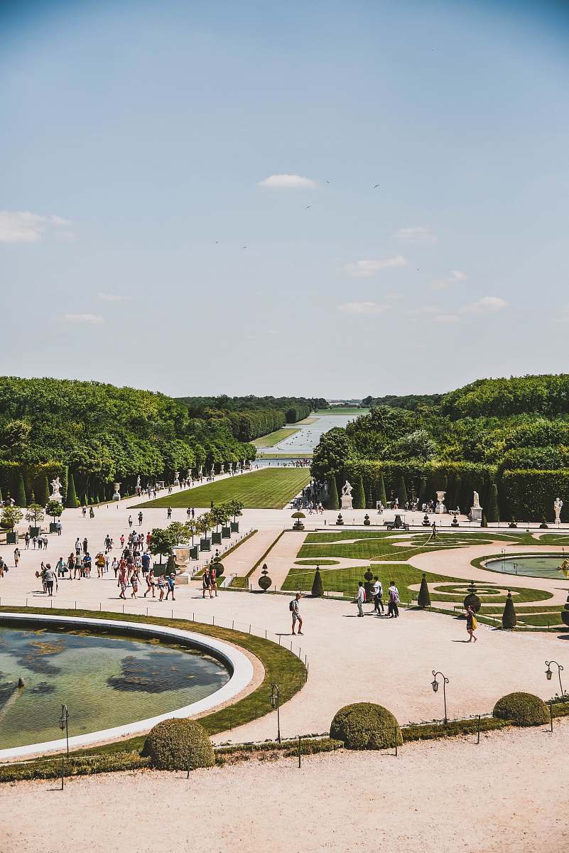town people standing beside fountain during daytime building