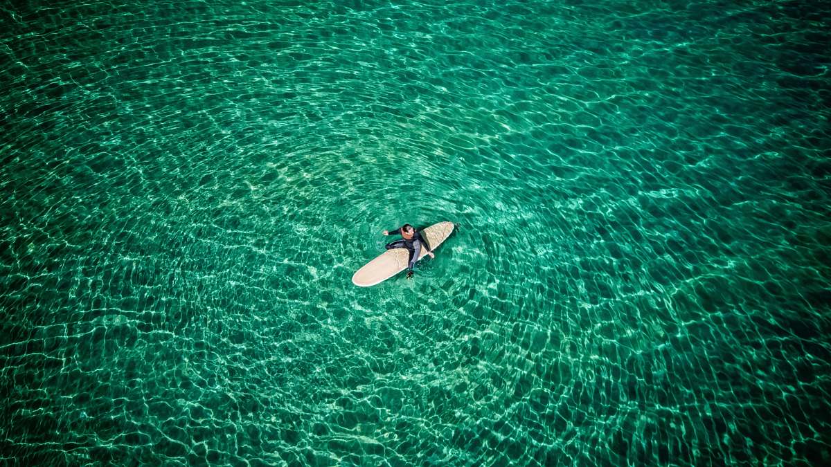 ocean woman surfing on body of water sea