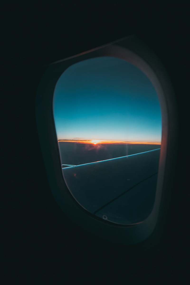 porthole window's plane photography of cloud mirror