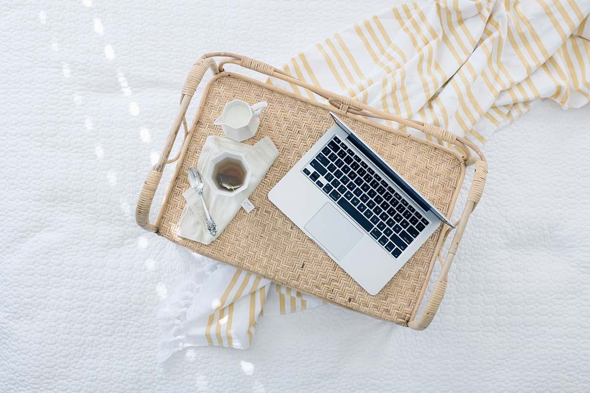 workspace gray laptop computer on beige wicker chair tea