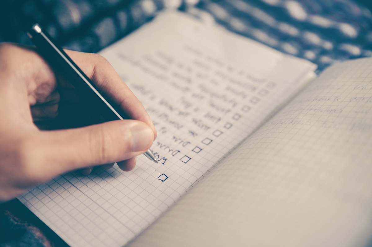 planning person writing bucket list on book text