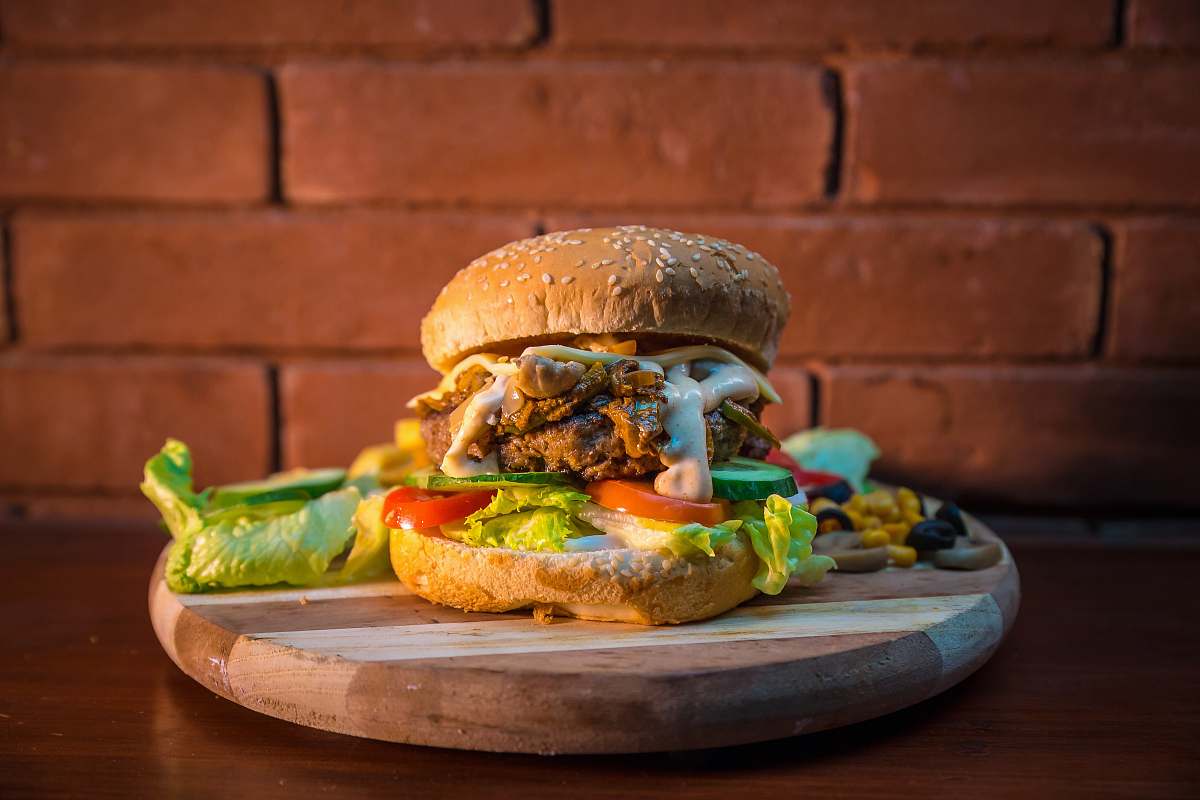 food bread with patty and sliced tomato and lettuce burger salad