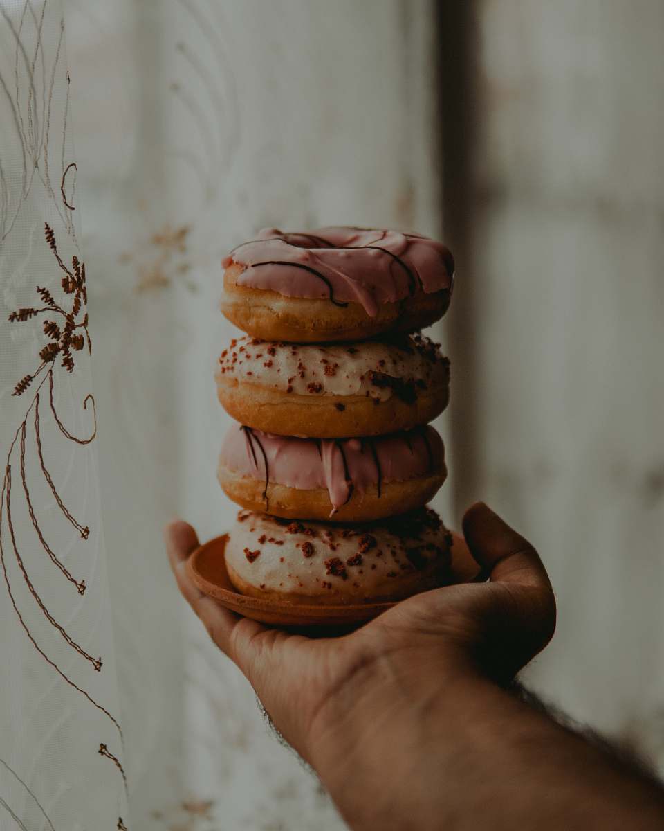 food person holding dougnuts human