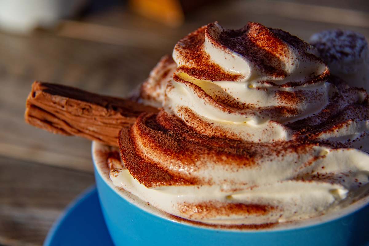 creme blue ceramic cup filled with coffee latte dessert