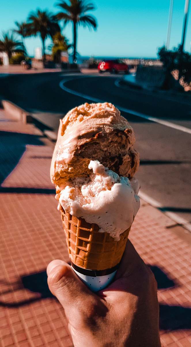 creme person holding ice cream dessert