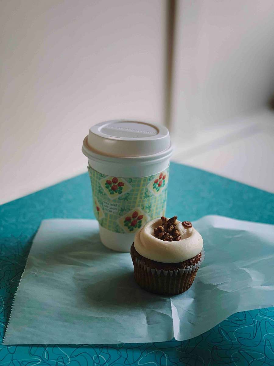 cake white and blue disposable cup beside chocolate cupcake cream