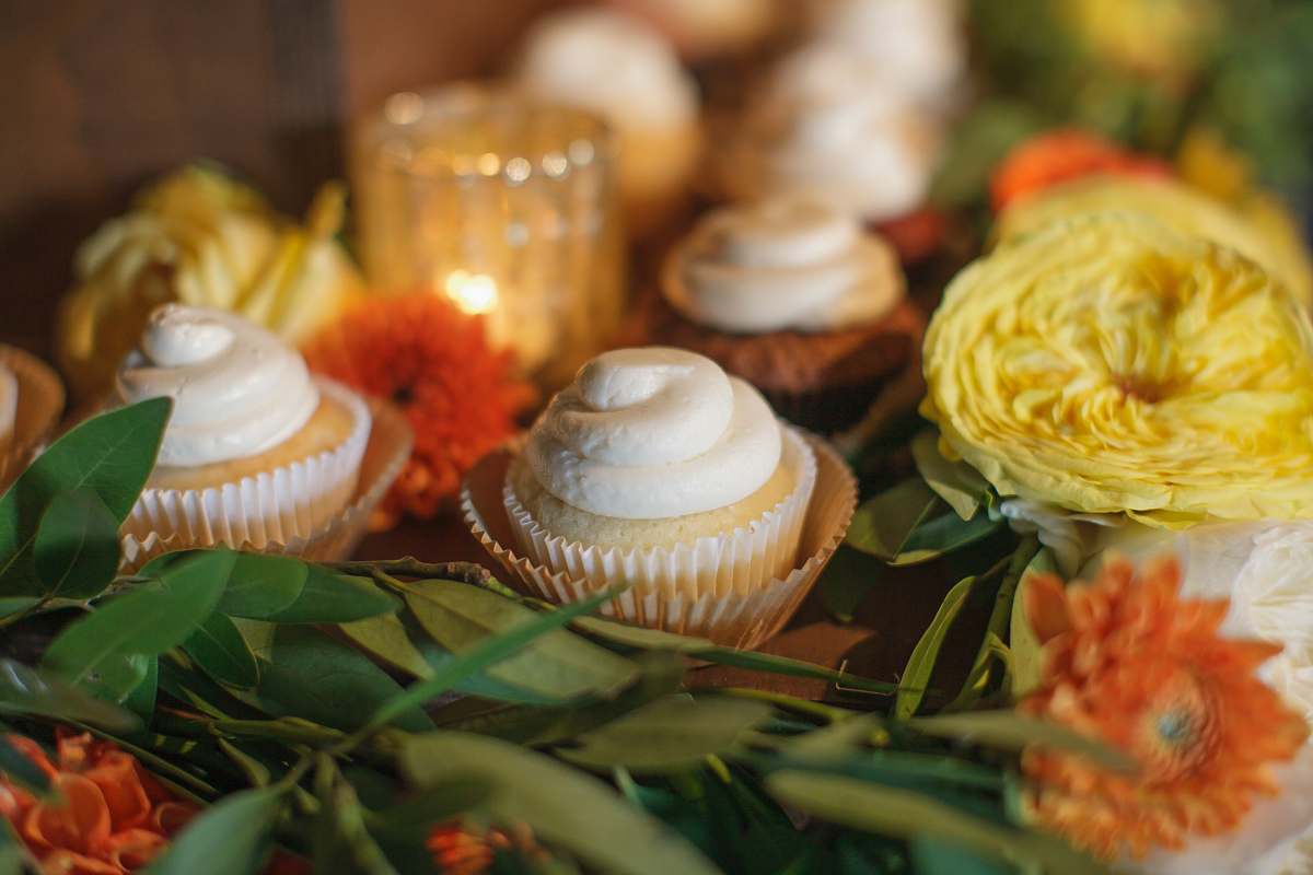 dessert baked cupcake beside yellow and orange flowers cake