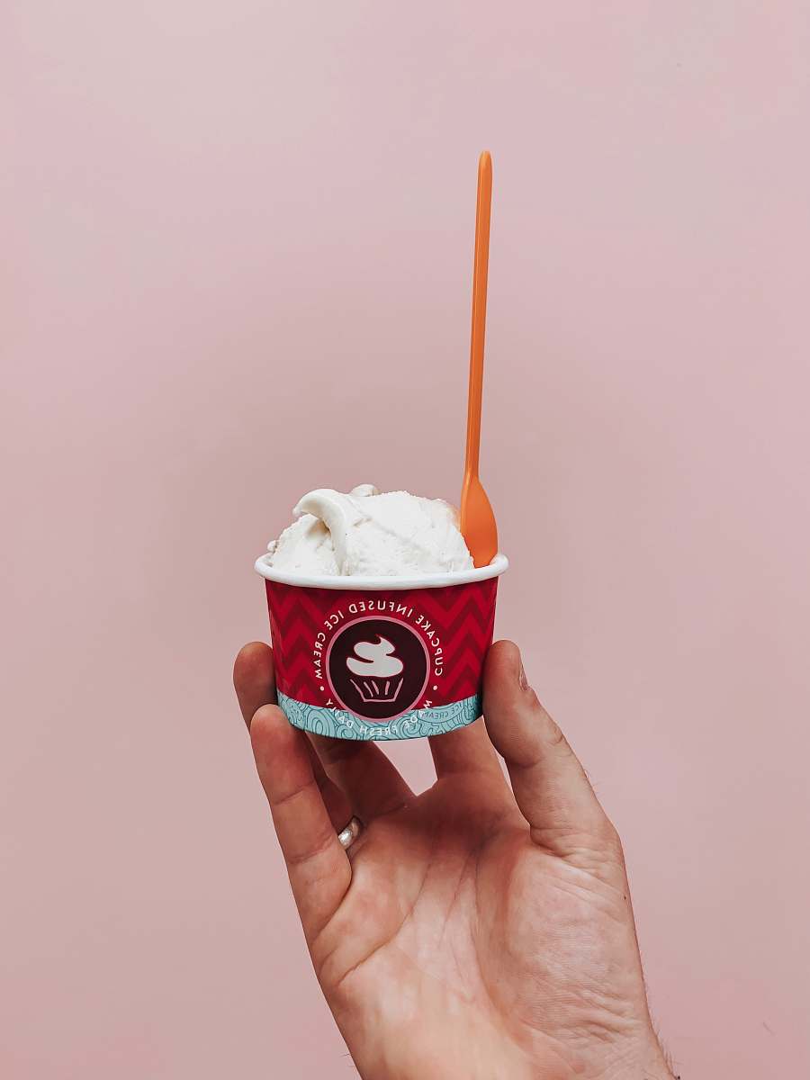 creme person holding cup of sundae cream