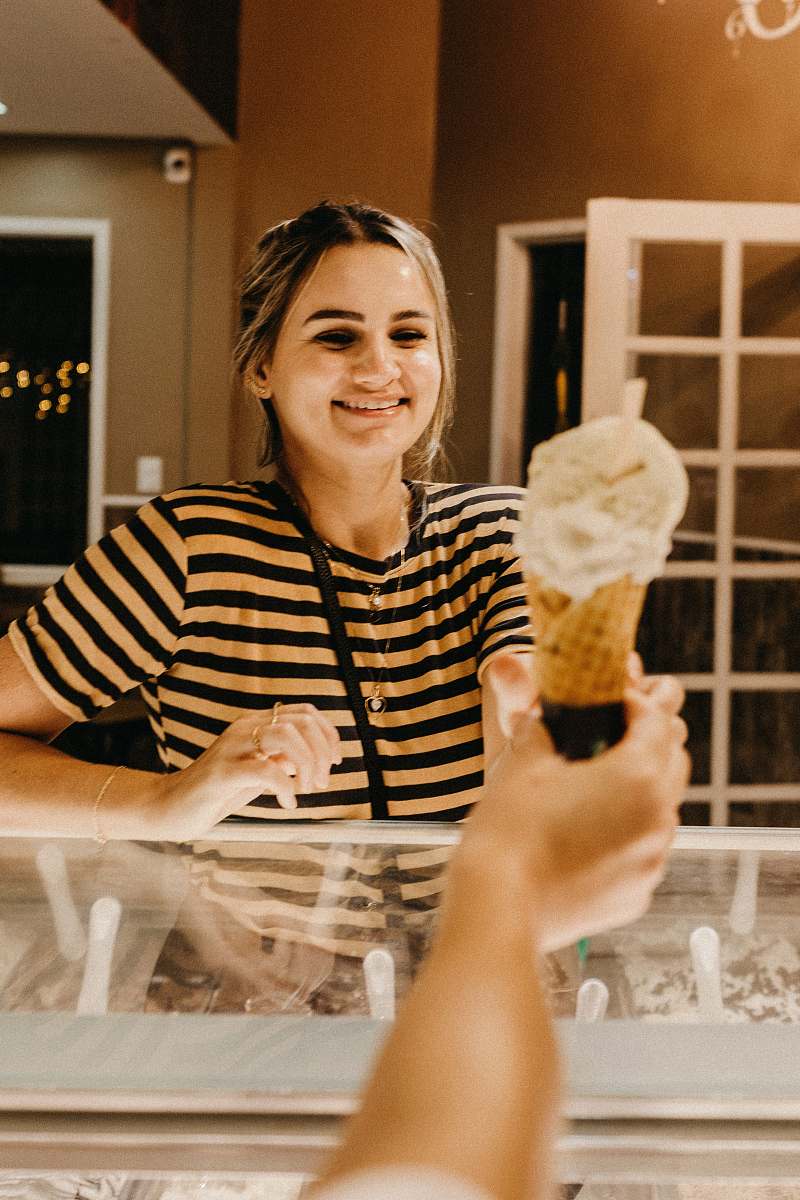 cream smiling woman reaching for ice cream creme