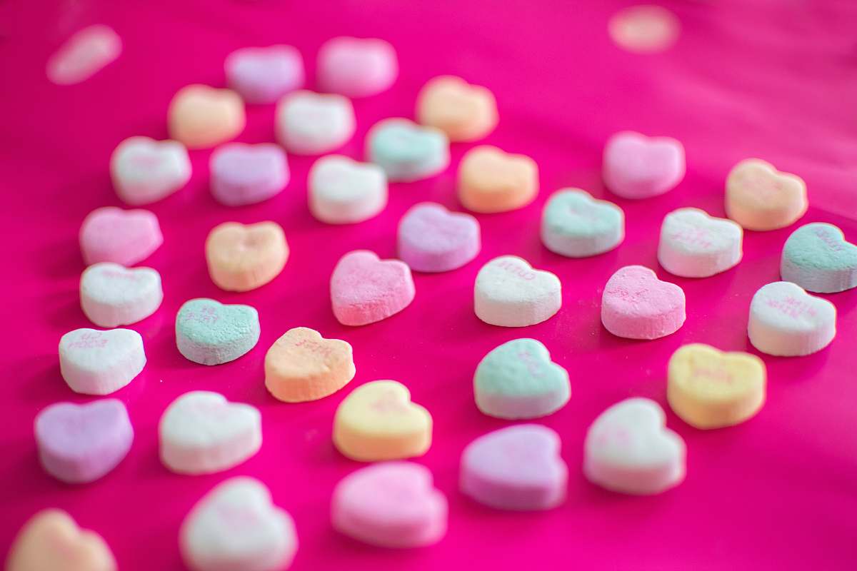 confectionery assorted-color heart candies on red textile sweets