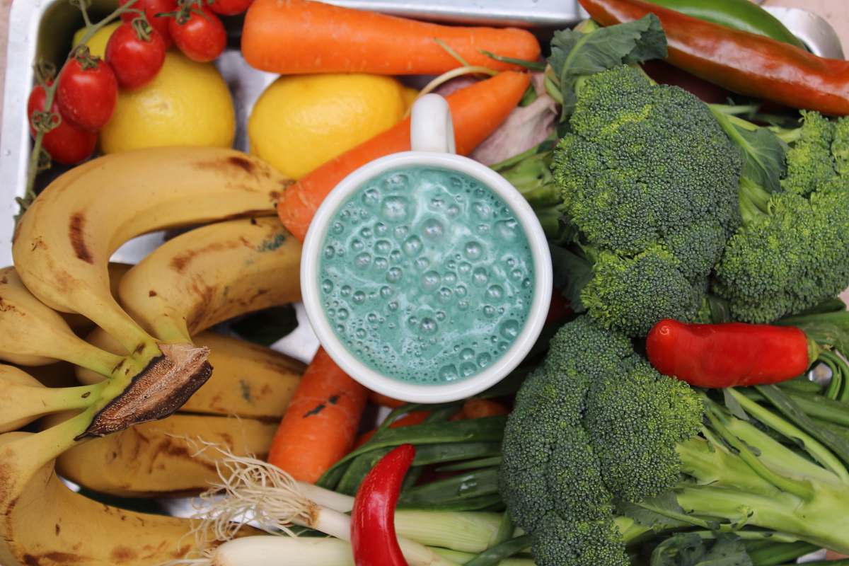 vegetable bananas, broccoli, and carrots beside white ceramic mug broccoli