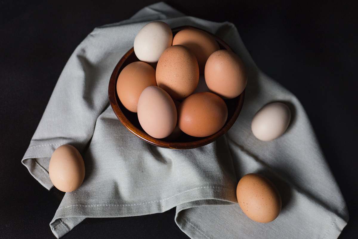 bowl beige and white eggs on brown wooden bowl eggs