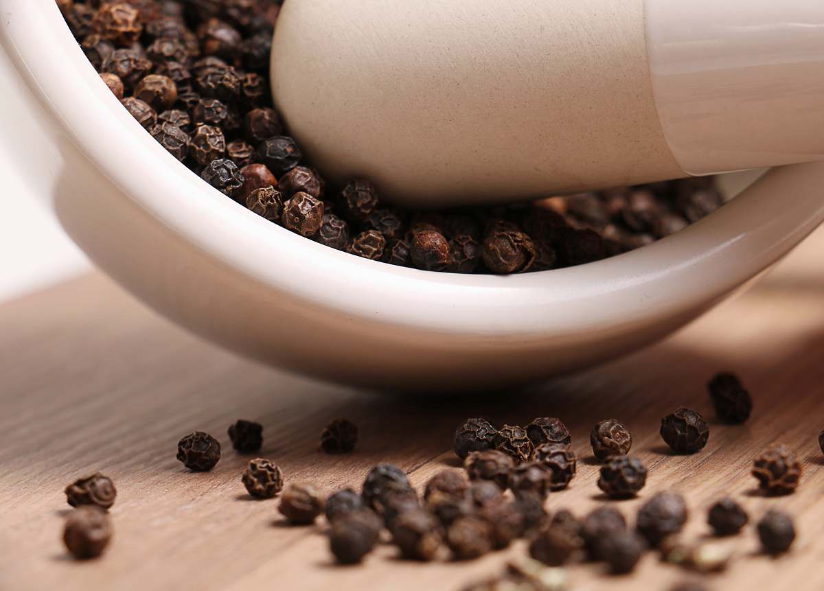 mortar black pepper on white ceramic mortar and pestle cannon