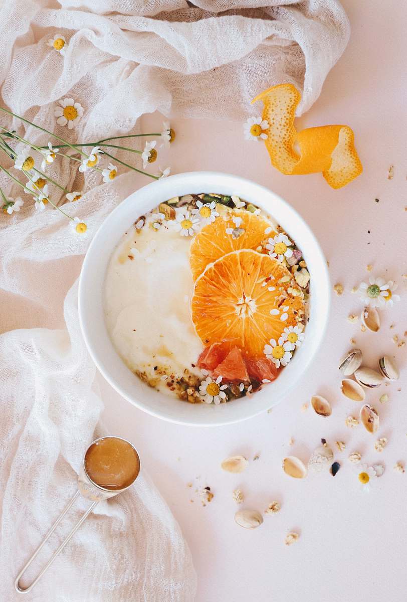 plant bowl of breakfast topped with oranges fruit