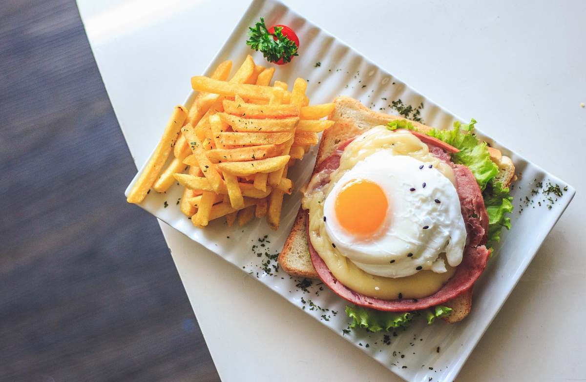 egg bread with egg and fries on plate burger