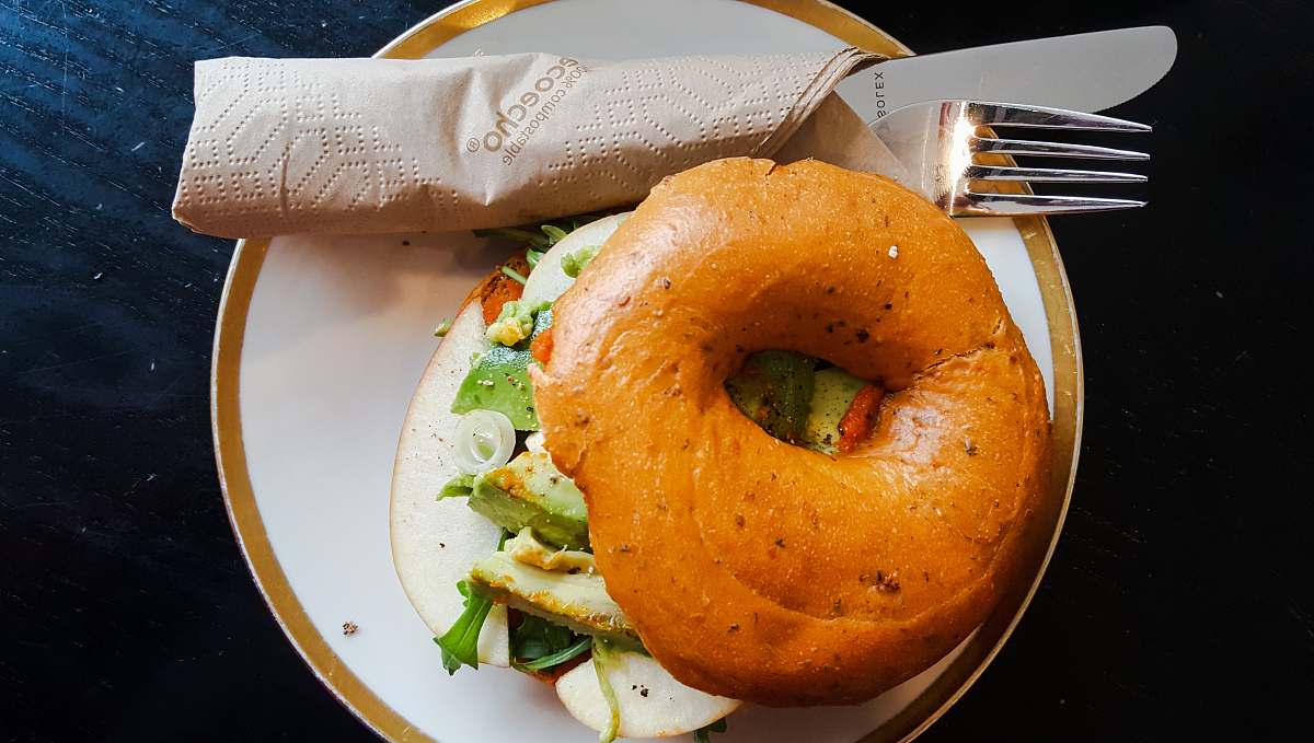 bread brown burger on round white and brown ceramic plate bagel