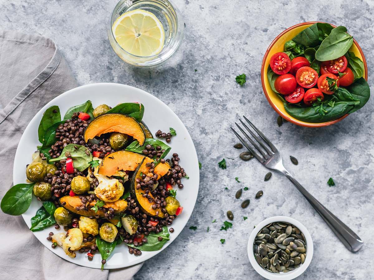 plant brussels sprout salad and red tomatoes with fork on table produce