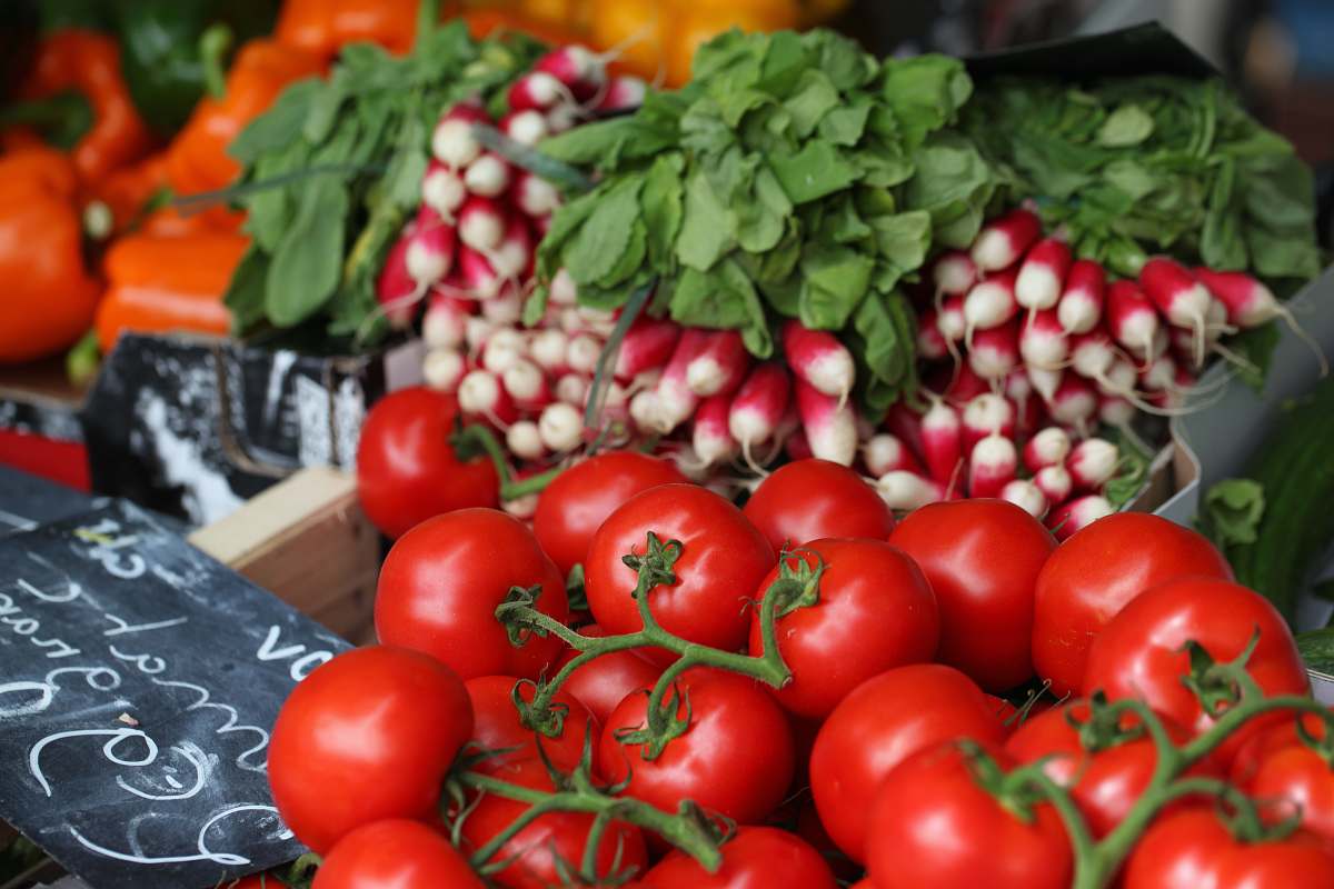 vegetable bunch of red tomatoes on top of black surface tomato