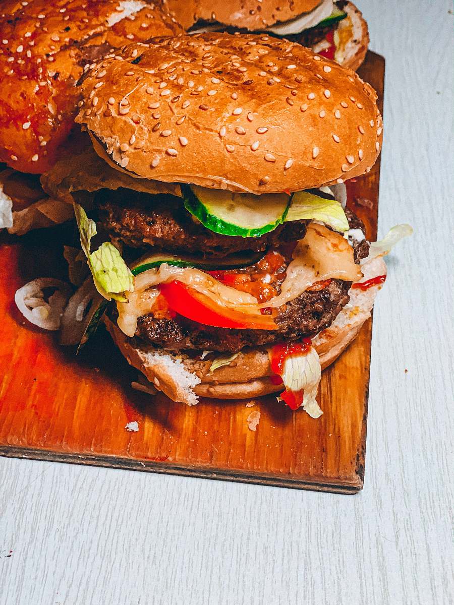 burger burger dish on brown chopping board 