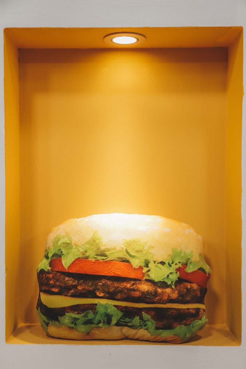burger burger displayed on yellow container orange