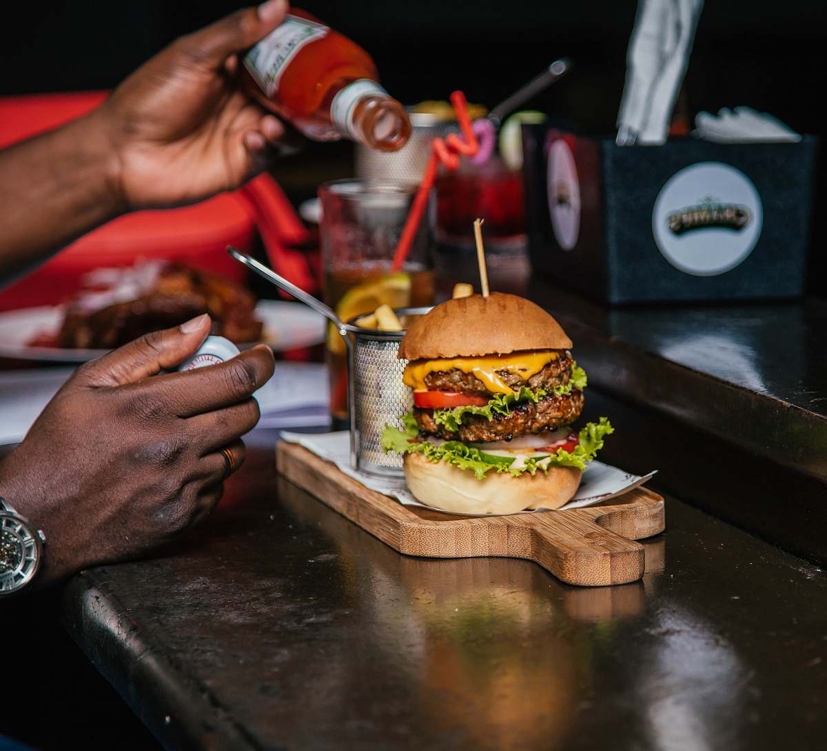 burger burger with sliced vegetable person