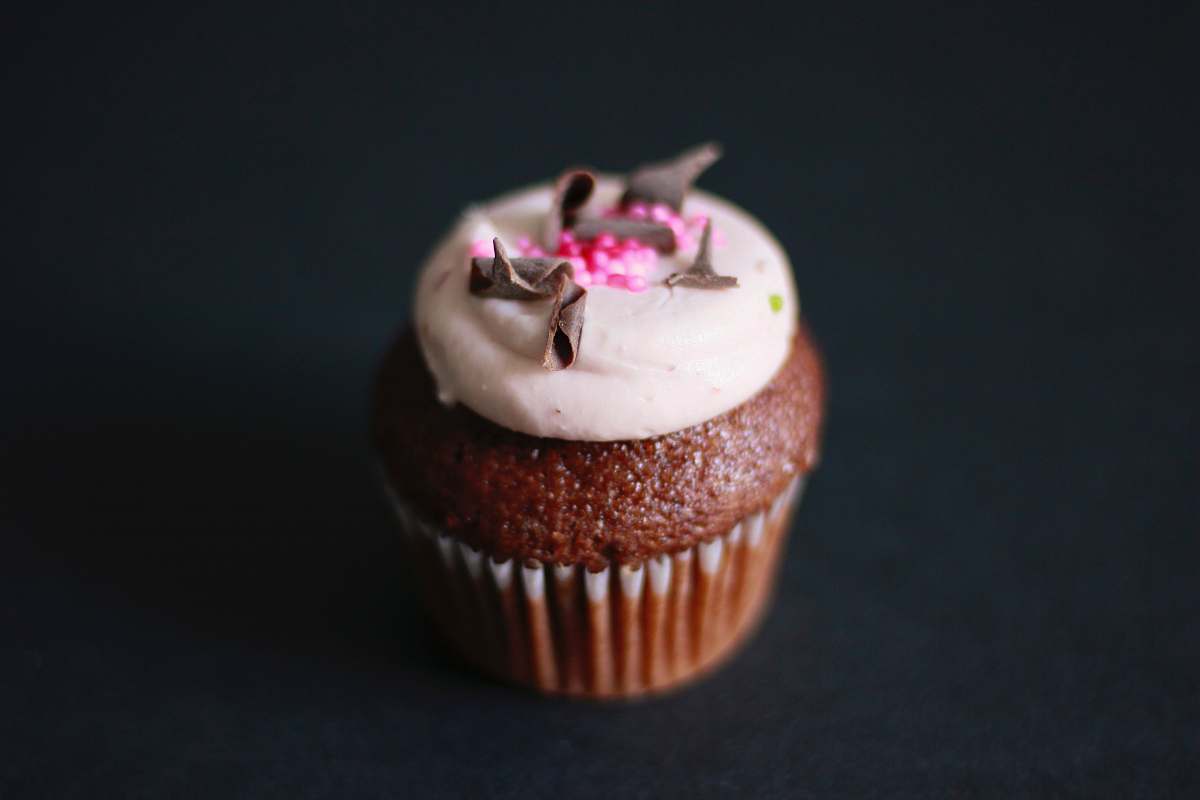 creme chocolate cupcake with white icing and grated chocolate dessert