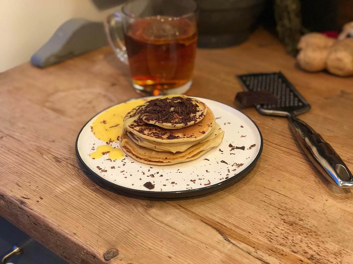 bread chocolate pancake served in white and black plate pancake