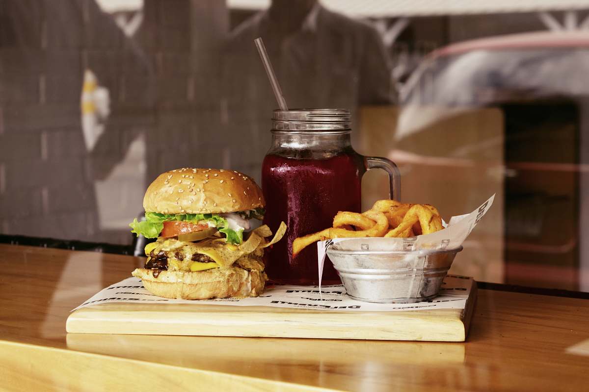 burger clear glass mason jar on brown wooden board beverage