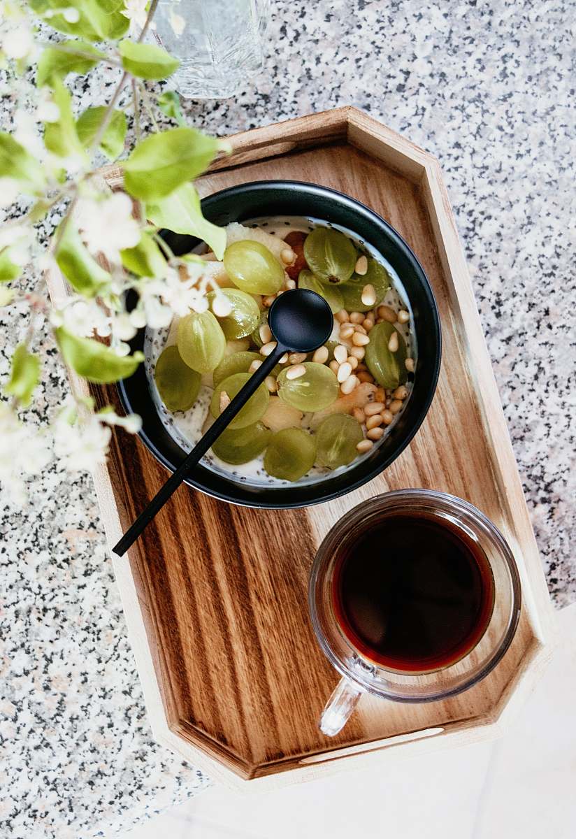 bowl clear glass mug on brown wooden tray meal