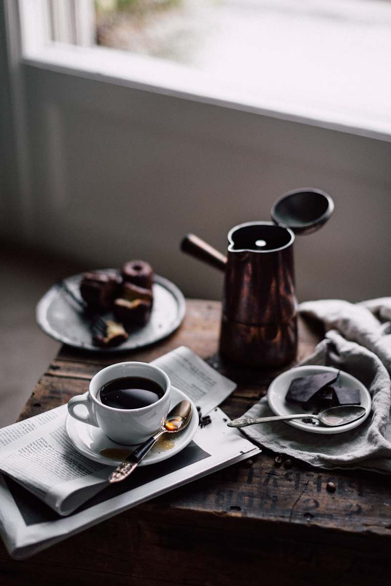 cup coffees in white ceramic mug on brown wooden table coffee