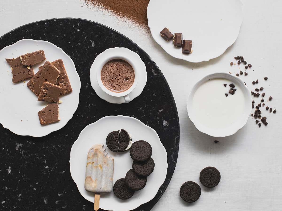 chocolate cookies on white ceramic plate with ice cream and chocolate drink dessert